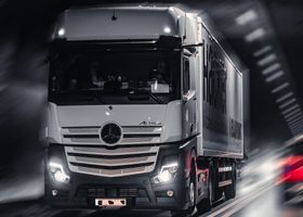 Mercedes-Benz Actros truck speeding through a city tunnel, capturing urban motion and energy.